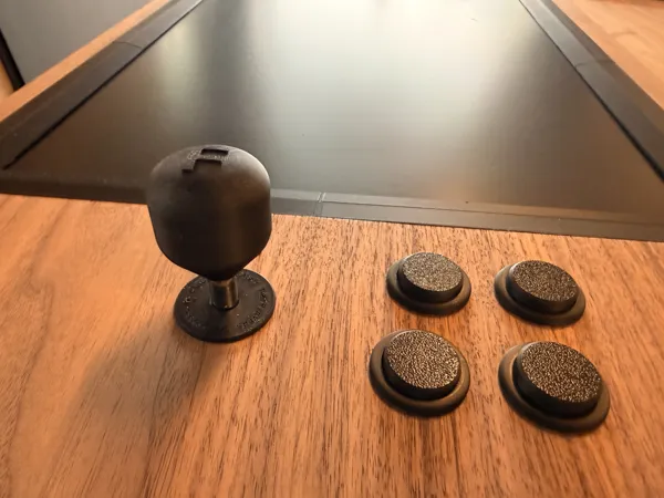 A stick and buttons set into the walnut