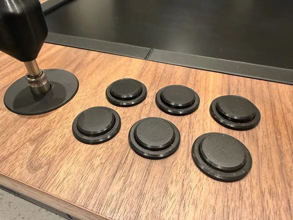 The buttons and the stick set into the walnut top