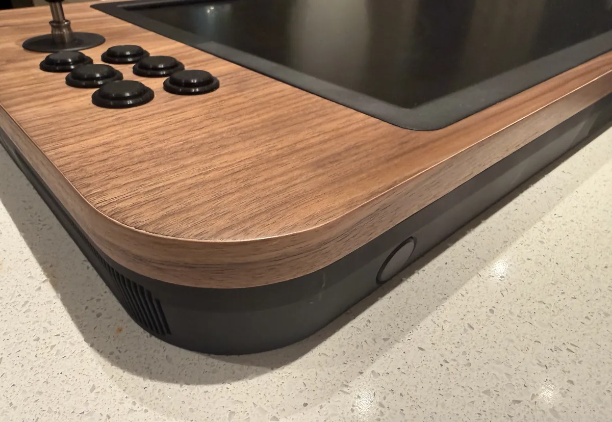 Photo of a rounded walnut corner over the black body
