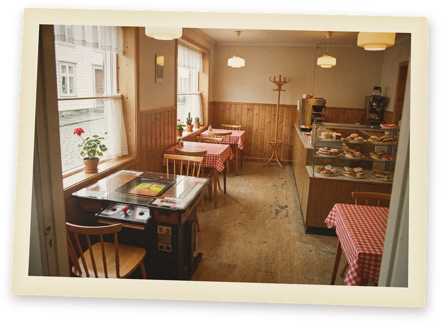 An old photo print: a Dig Dug cocktail arcade table in an empty Norwegian café in the early 1980s